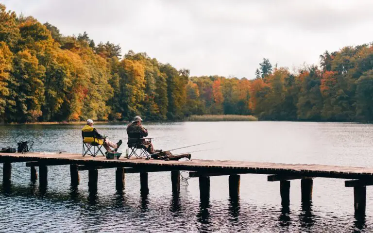 two men fishing on lake