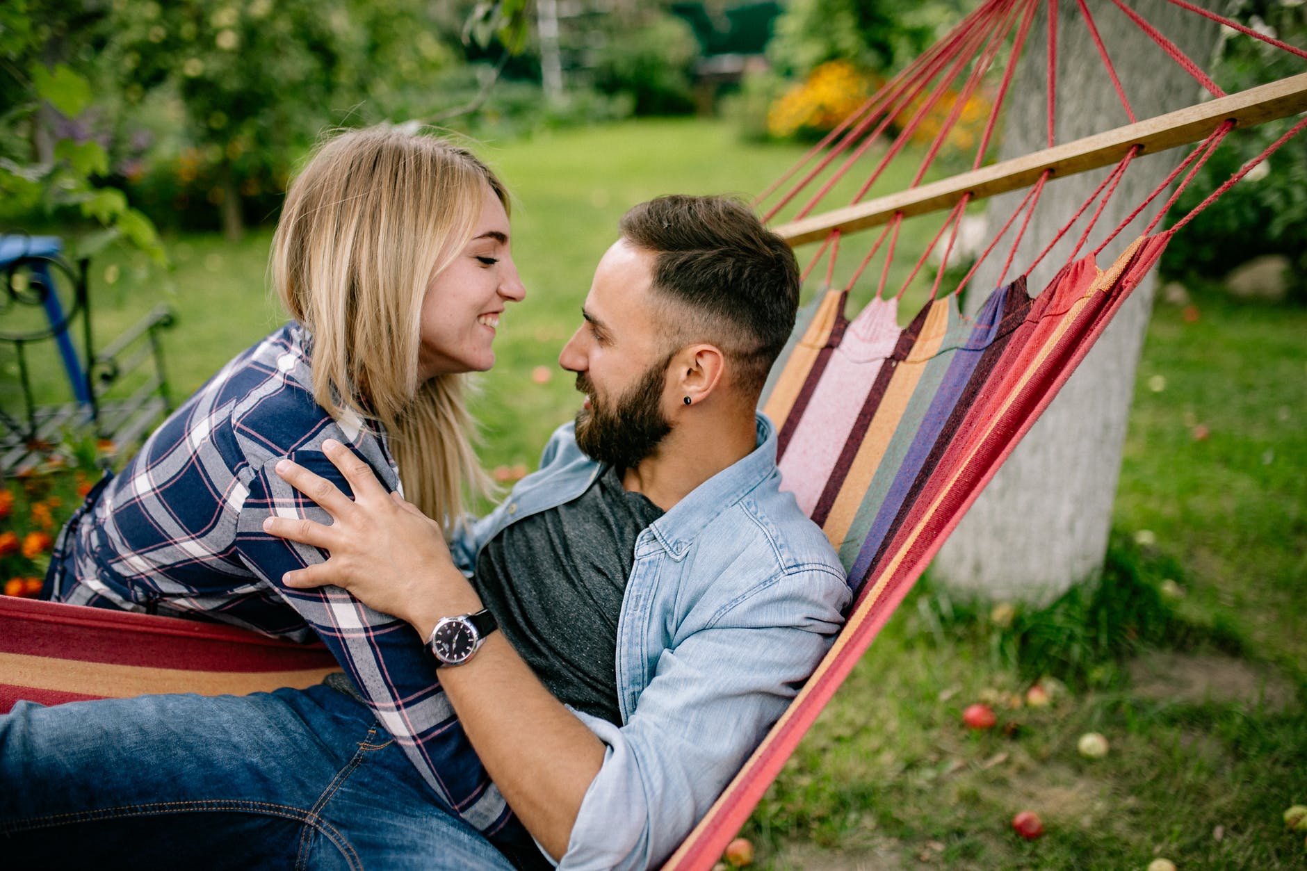 a woman hugging a man on a hammock