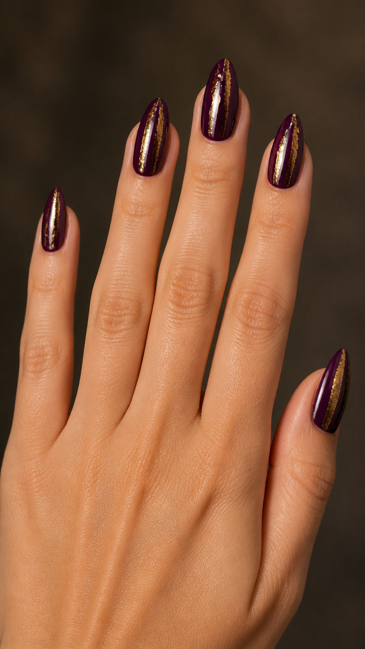 Gold Foil Stripes Over Deep Plum Almond Nails